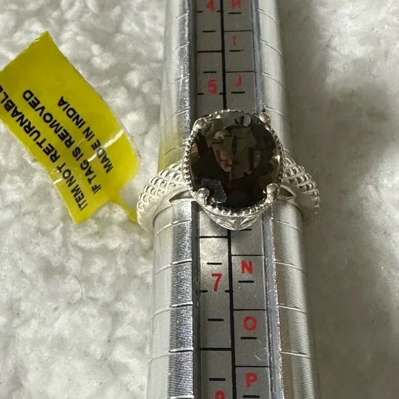 This is a sterling silver ring featuring a smoky quartz gemstone
